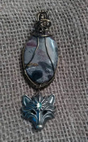 Porcelain Jasper/Wolf head Pendant.
  Item #P580 
$20 - (1) available 
Pendant Cord Necklace included