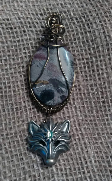 Porcelain Jasper/Wolf head Pendant.
  Item #P580 
$20 - (1) available 
Pendant Cord Necklace included